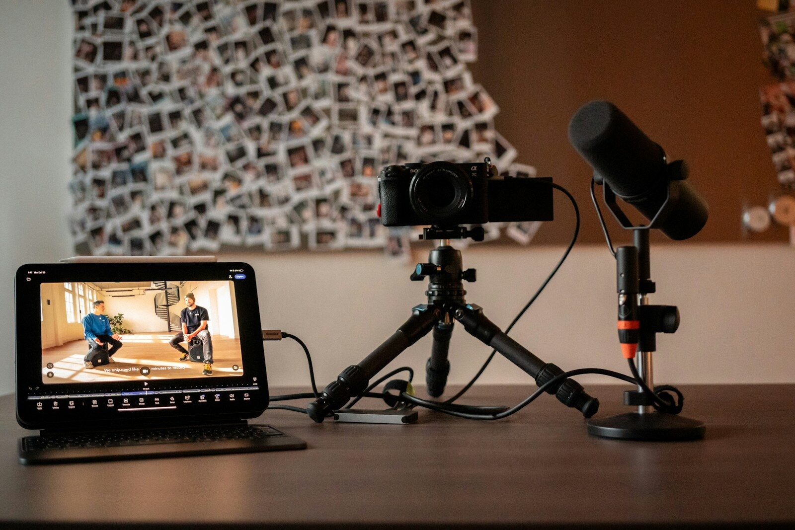 Camera, microphone, and monitor on a desk.