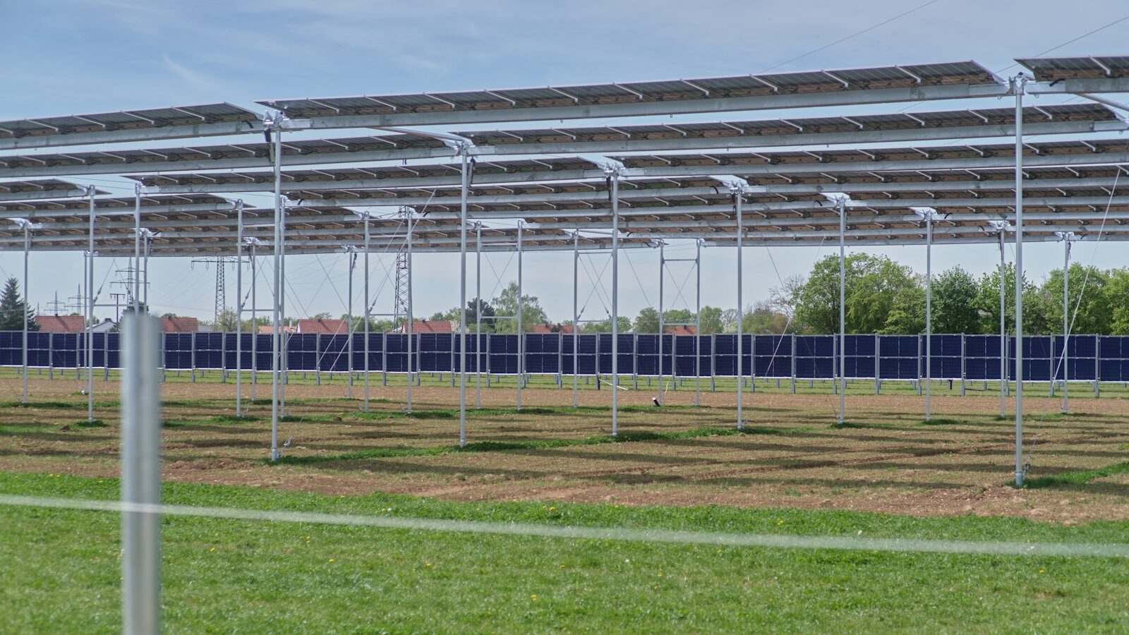 a row of metal poles in a field